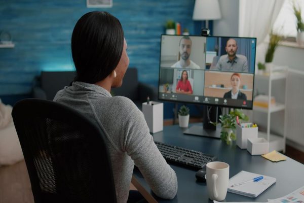 black-student-discussing-marketing-academic-ideas-with-college-team-having-virtual-teleconference-meeting-sitting-at-desk-in-living-room (1)