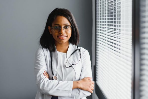 smiling-young-adult-indian-female-doctor-wear-white-coat-in-medical-clinic-office-happy-beautiful-health-care-india-professional-medic-physician-therapist-headshot-portrait (1)